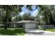 Newly built home with gray exterior, landscaped yard, and a two-car garage at 1730 Old Apopka Rd, Apopka, FL 32703