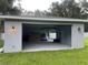 Spacious detached garage with high ceilings and concrete floor at 1730 Old Apopka Rd, Apopka, FL 32703