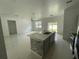 Open concept kitchen with island and view into living room at 1730 Old Apopka Rd, Apopka, FL 32703