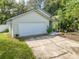 Single-story house with white garage door and green exterior at 4446 Weeping Willow Cir, Casselberry, FL 32707