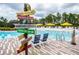 Community pool with lounge chairs and a fun sign at 301 Captiva Dr, Davenport, FL 33896