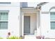 Gray front door with simple landscaping at 301 Captiva Dr, Davenport, FL 33896