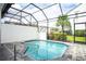 Private screened pool with surrounding community view at 301 Captiva Dr, Davenport, FL 33896