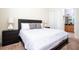 Bright bedroom featuring a queen-size bed and ensuite bathroom access at 301 Captiva Dr, Davenport, FL 33896
