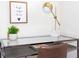 Study with glass-top desk, brown chair, and decor at 301 Captiva Dr, Davenport, FL 33896