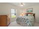 Bright bedroom with seashell bedding, dresser, and window view at 114 Ridge View Dr, Davenport, FL 33837