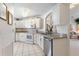 Modern kitchen with white cabinets, granite counters, and stainless steel appliances at 114 Ridge View Dr, Davenport, FL 33837
