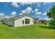 Side view of a house showcasing a large window and lush green lawn at 114 Ridge View Dr, Davenport, FL 33837