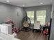 Spacious and bright playroom with a comfy hanging chair and plenty of room for toys at 7132 Five Oaks Dr, Saint Cloud, FL 34773