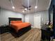 Large main bedroom with a king-size bed, ample floor space and ceiling fan at 7132 Five Oaks Dr, Saint Cloud, FL 34773