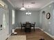 Charming dining room with a four-person table set and chandelier at 7132 Five Oaks Dr, Saint Cloud, FL 34773