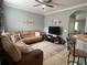 Bright living room with a large sectional sofa and ample natural light at 7132 Five Oaks Dr, Saint Cloud, FL 34773