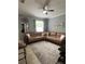 Relaxing living room featuring a sectional sofa and ceiling fan at 7132 Five Oaks Dr, Saint Cloud, FL 34773