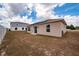 View of the backyard with a tan house and some grass at 340 Elderberry Ct, Kissimmee, FL 34759