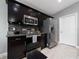 Modern kitchen with dark cabinets and stainless steel appliances at 340 Elderberry Ct, Kissimmee, FL 34759