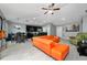 Bright living room with orange couch and adjacent kitchen at 340 Elderberry Ct, Kissimmee, FL 34759