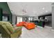 Living room with orange sectional sofa and green accent wall at 340 Elderberry Ct, Kissimmee, FL 34759