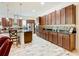 Open kitchen boasts dark wood cabinets, granite counters, and stainless steel appliances at 2516 Pickett Ave, Saint Cloud, FL 34772
