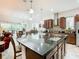 Kitchen island with granite countertop, seating, and stainless steel appliances at 2516 Pickett Ave, Saint Cloud, FL 34772