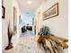 Long hallway with wood bench and art at 2516 Pickett Ave, Saint Cloud, FL 34772