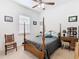 Guest bedroom with a wooden four-poster bed and a desk at 2516 Pickett Ave, Saint Cloud, FL 34772