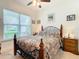 Bright bedroom with a floral comforter and wooden furniture at 2516 Pickett Ave, Saint Cloud, FL 34772
