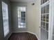 Bright condo office with large window overlooking patio, and dark wood floors at 239 Longview Ave # 107, Celebration, FL 34747