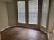 Bright bedroom with three windows and dark brown flooring at 239 Longview Ave # 107, Celebration, FL 34747