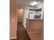 Condo kitchen with white cabinets, breakfast bar, and dark wood floors at 239 Longview Ave # 107, Celebration, FL 34747