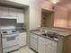 Efficient kitchen with white cabinets, gas range, and dishwasher at 239 Longview Ave # 107, Celebration, FL 34747
