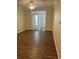Spacious living room featuring wood-look floors and access to a sunroom at 239 Longview Ave # 107, Celebration, FL 34747