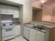 Kitchen with white cabinets, stainless steel sink, and appliances at 239 Longview Ave # 107, Celebration, FL 34747