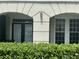 Exterior view of condo building with double doors and lush landscaping at 239 Longview Ave # 107, Celebration, FL 34747