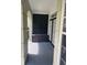 Private condo patio with black storage bench and access to double doors at 239 Longview Ave # 107, Celebration, FL 34747