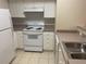 Kitchen boasts white cabinets and a full suite of appliances at 239 Longview Ave # 107, Celebration, FL 34747