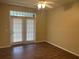 Bedroom with double doors leading to patio/balcony and ceiling fan at 239 Longview Ave # 107, Celebration, FL 34747