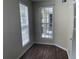 Bright condo office with large window overlooking patio, and dark wood floors at 239 Longview Ave # 107, Celebration, FL 34747