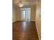 Spacious living room featuring wood-look floors and access to a sunroom at 239 Longview Ave # 107, Celebration, FL 34747