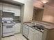 Efficient kitchen with white cabinets, gas range, and dishwasher at 239 Longview Ave # 107, Celebration, FL 34747
