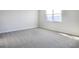 Bright bedroom with carpeted floors and large window at 4043 Bannock Ave, Tavares, FL 32778