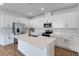 Modern kitchen featuring white cabinets, stainless steel appliances, and an island at 4043 Bannock Ave, Tavares, FL 32778