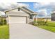 Front view of charming house with a two-car garage and landscaped yard at 6357 Clover St, Lake Hamilton, FL 33851