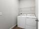 Laundry room with washer, dryer, and overhead shelving at 6357 Clover St, Lake Hamilton, FL 33851