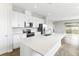 Modern kitchen featuring white cabinets, stainless steel appliances, and a large island at 6357 Clover St, Lake Hamilton, FL 33851