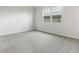Simple bedroom with grey carpeting and a large window at 6357 Clover St, Lake Hamilton, FL 33851