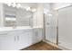 Bathroom with double vanity, large mirror, and a glass shower at 6357 Clover St, Lake Hamilton, FL 33851