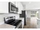 Stainless steel appliances and white cabinetry in a modern kitchen at 6357 Clover St, Lake Hamilton, FL 33851