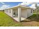 House exterior with covered patio and grassy yard at 6357 Clover St, Lake Hamilton, FL 33851