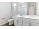 Modern bathroom with white vanity, shower, and tile flooring at 6357 Clover St, Lake Hamilton, FL 33851