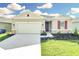 Attractive house exterior, two-car garage, and well-maintained landscaping at 3120 Kacee Dr, Eagle Lake, FL 33839